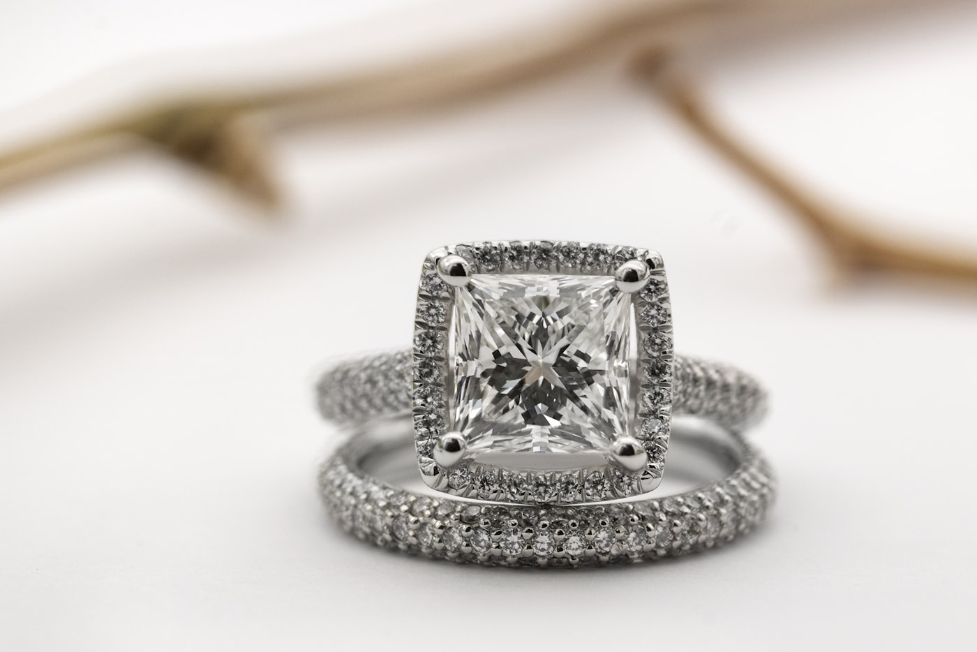 Pavé halo engagement ring and matching band, princess cut center stone