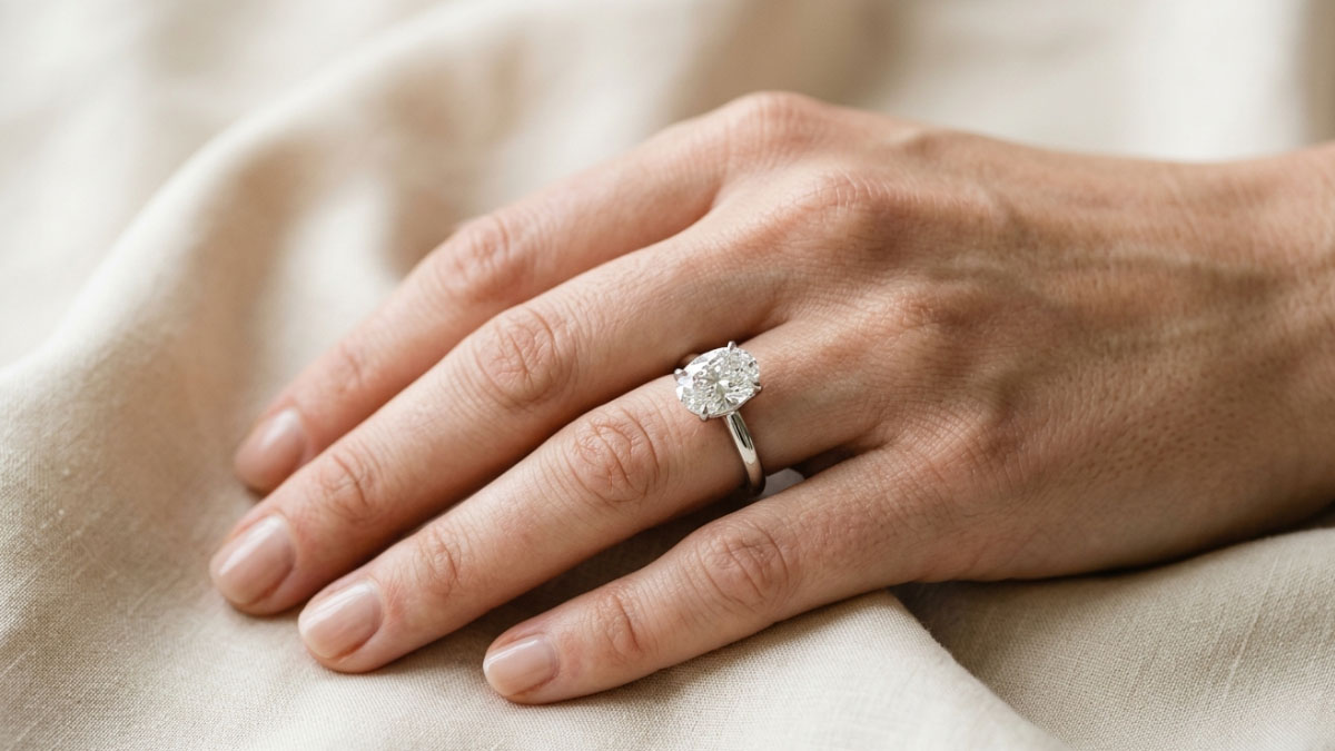 Solitaire diamond engagement ring on hand with simple wearable style