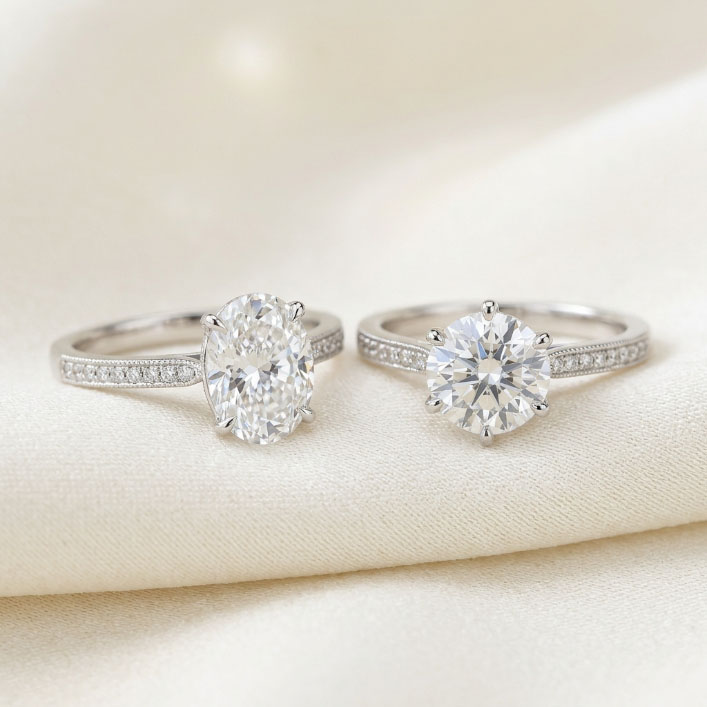 Oval and round diamond engagement ring settings shown side by side.