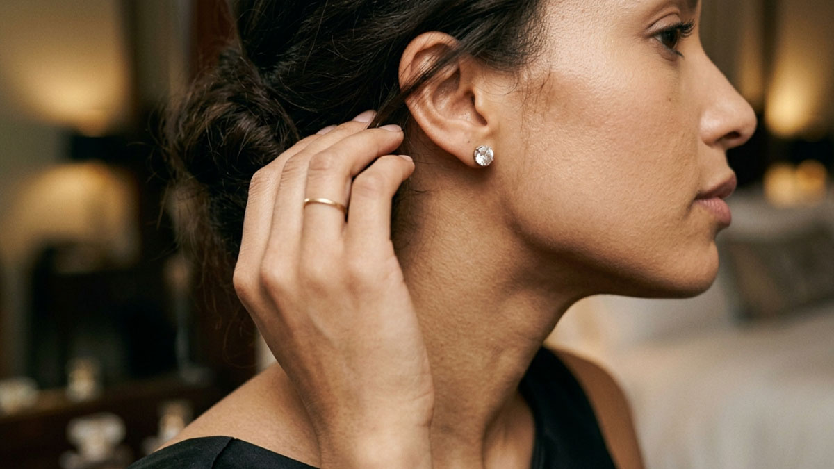 Diamond earrings worn as a subtle formal dinner styling detail