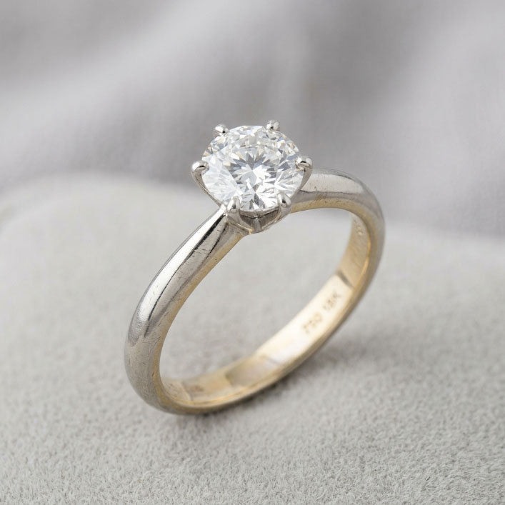 18K white gold diamond ring showing subtle warm reflections as rhodium plating wears.