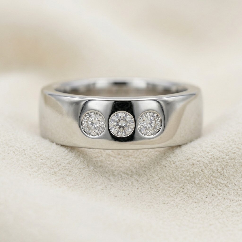 Wide platinum band with three flush set diamonds in a row.